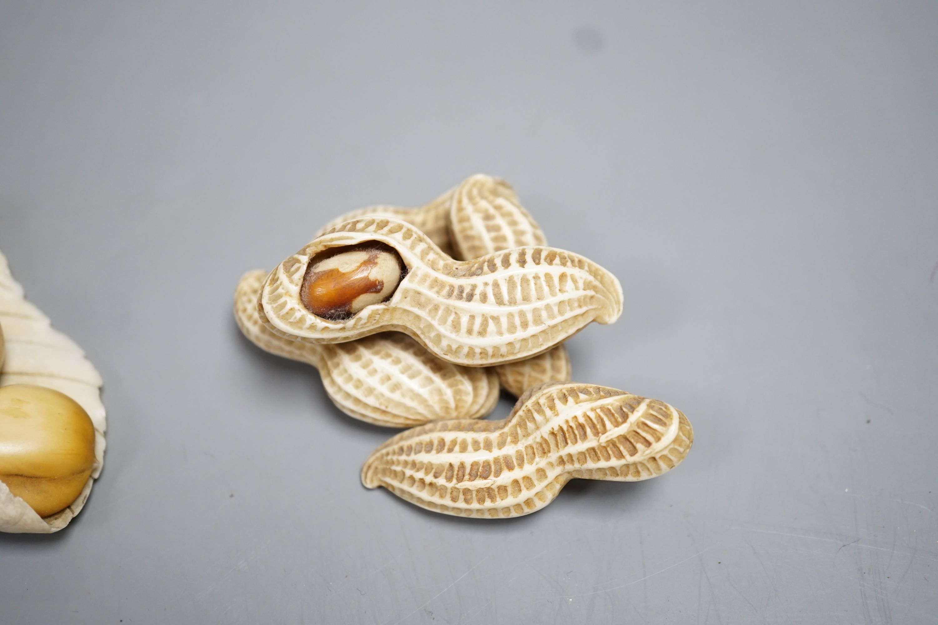 Two Japanese Ivory models of group groups of nuts, first half 20th century, largest 11cm